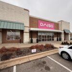 Daiso Retail Store With Large Pink Signage And Clean Exterior Landscaping Parking Lot With A White Vehicle Nearby