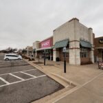 Daiso Store Front With A Large Pink Sign And Green Awnings In A Shopping Plaza On A Cloudy Day