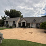 residential exterior cleaning with well-maintained landscaping and a clear driveway showcasing a clean entryway and stone features