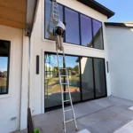 professional window cleaning in progress with equipment and staff ensuring spotless shine for commercial properties in edmond ok